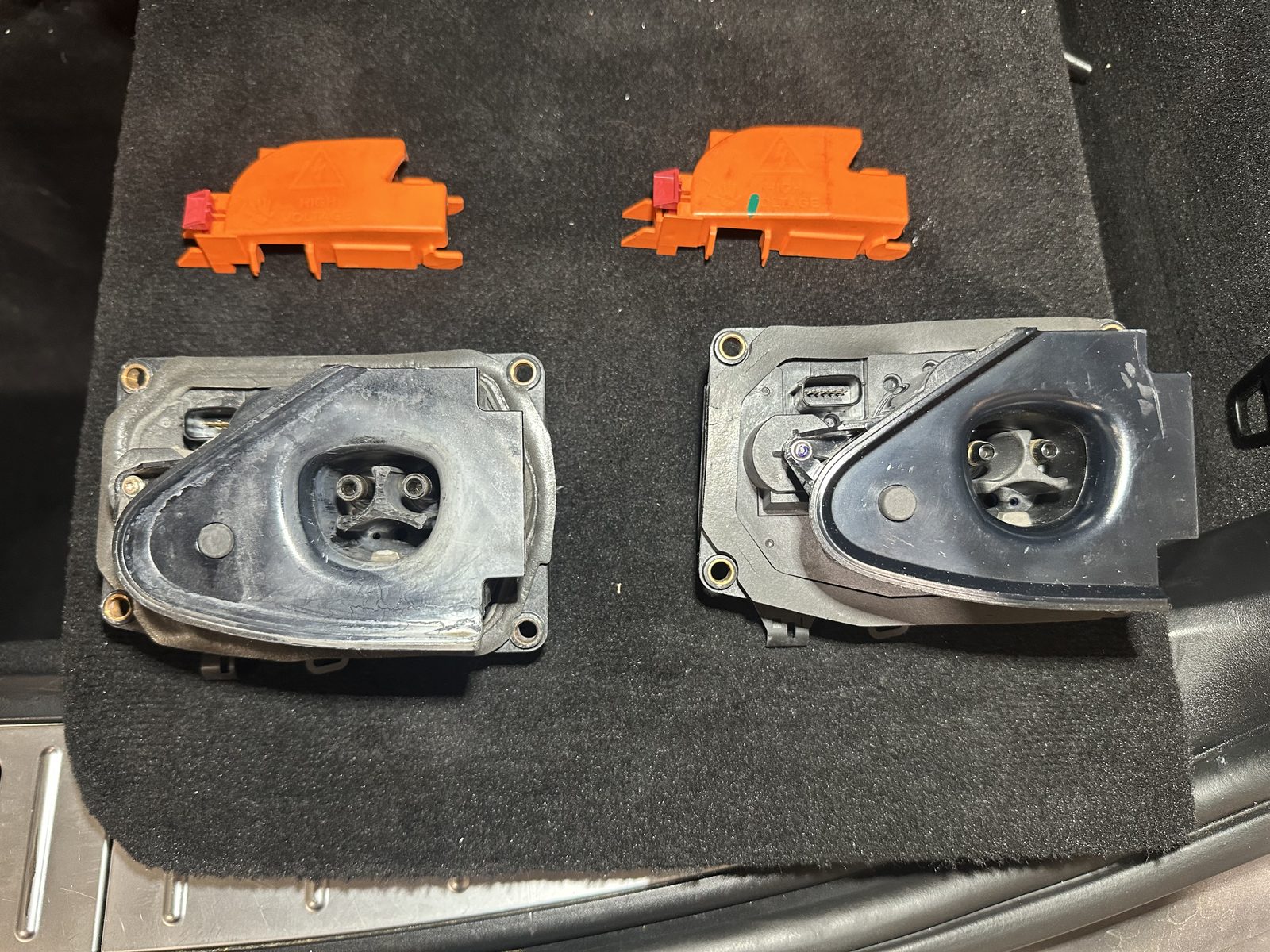 Worn and new Tesla charge port inlet assemblies replaced at HighVolt EV near Charlotte, NC